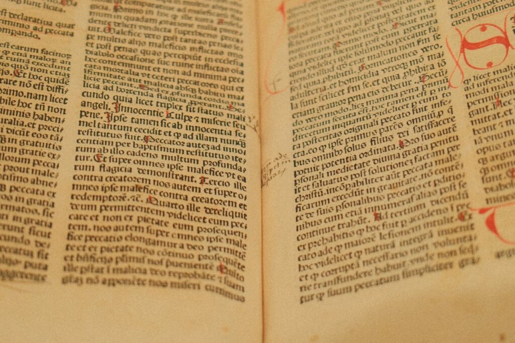 Detailed image of an ancient manuscript featuring Latin text on yellowed pages.
